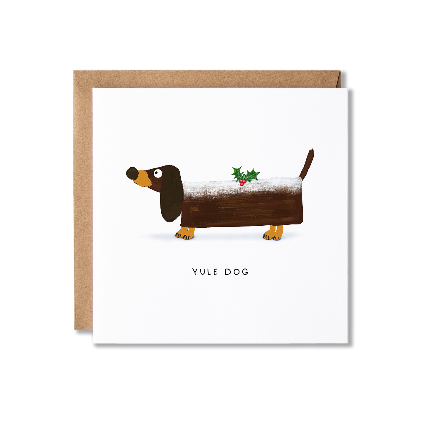 Christmas card with illustration of a Dachshund sausage dog wearing a log shape that looks like a Yule log with a spring of holly on top and the message Yule Dog.